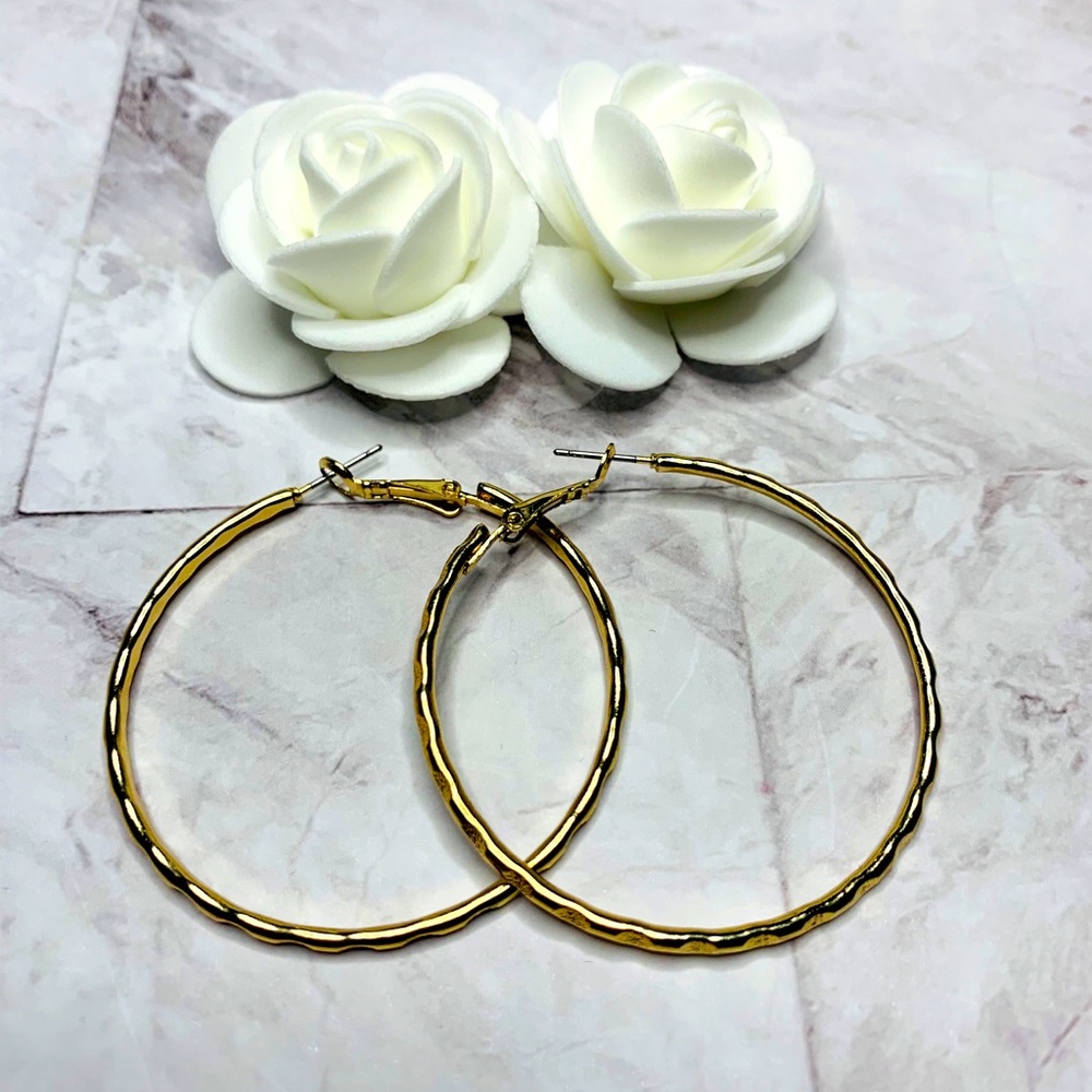 Gold tone hoop earrings with easy closure.